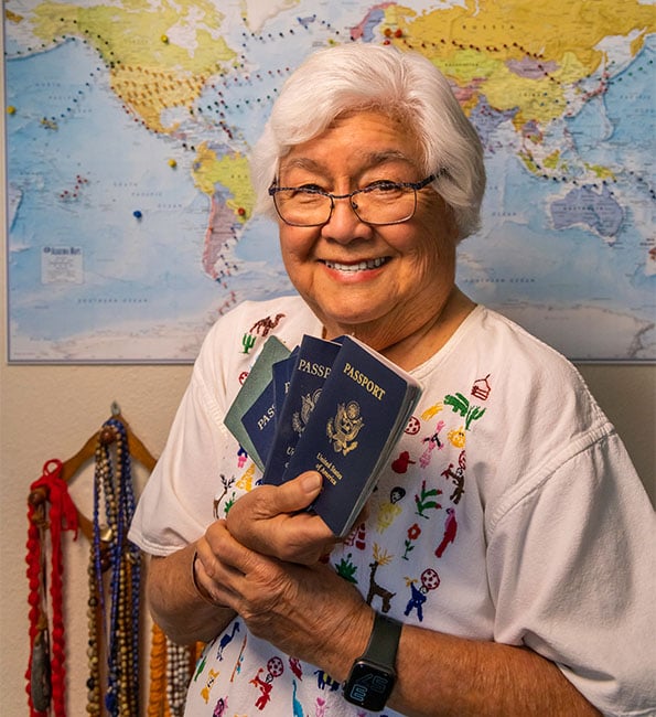 Janet smiling and holding up passport